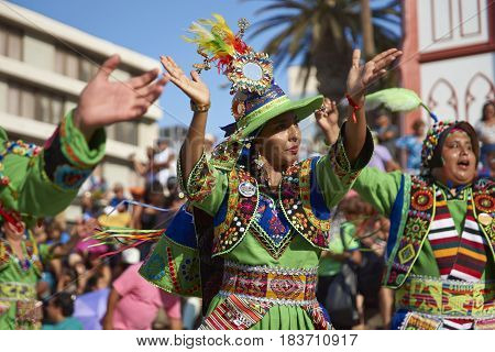 ARICA, CHILE - FEBRUARY 11, 2017: Tinkus dancers dressed in ornate costumes performing during a street parade at the annual Carnaval Andino con la Fuerza del Sol in Arica, northern Chile.
