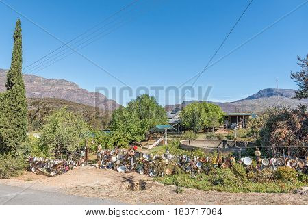 BARRYDALE SOUTH AFRICA - MARCH 25 2017: A fence decorated with old enamel ware in Barrydale a small town on the scenic Route 62 in the Western Cape Province