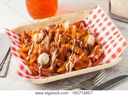 Colombian food: typical salchipapas with quail eggs.