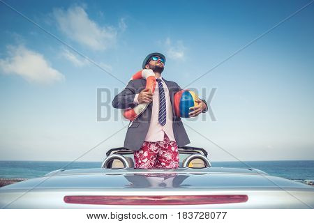 Businessman Standing On A Beach Near Car