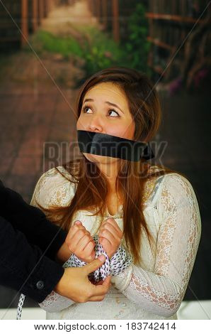 CLose up portrait of terrified young girl kidnapped and bonded
