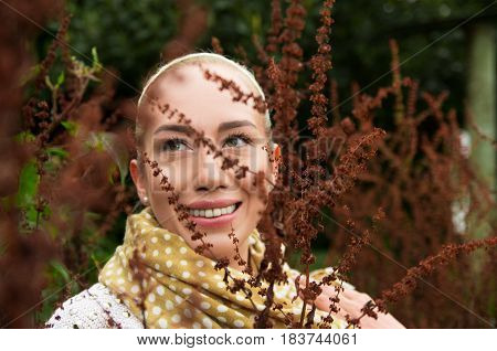 Close up portrait of smiling beautiful woman enjoying nature in a forest