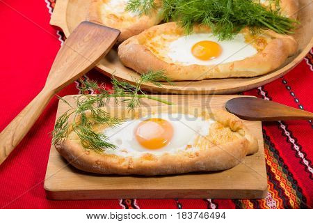 ajarian khachapuri dish of Georgian cuisine, Georgian national pastry, which is a flatbread with cheese. baked in the shape of boats and pour the egg
