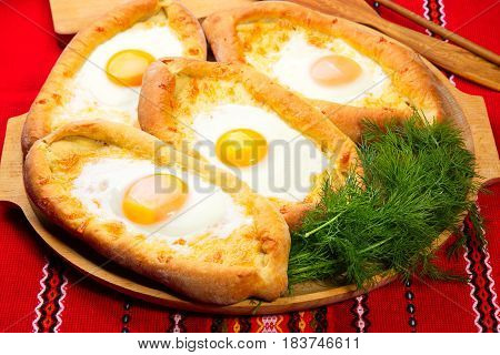 ajarian khachapuri dish of Georgian cuisine, Georgian national pastry, which is a flatbread with cheese. baked in the shape of boats and pour the egg