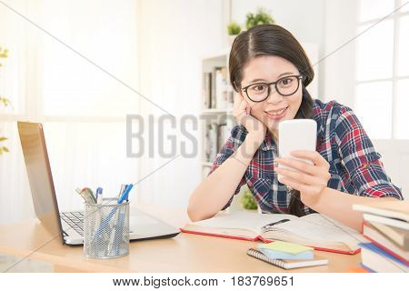 Student Learning With Laptop And Texting