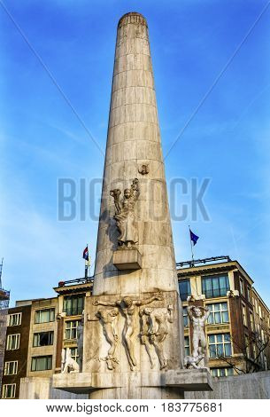 National World War II Monument Dam Square Amsterdam Holland Netherlands. Built in 1956 Sculptor Paul Gregoire. Four Chained men representing suffering in World War II Christ like figure in center.