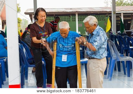 CHIANG RAI THAILAND - FEBRUARY 20 : unidentified couple helping leprosy asian old man on February 20 2016 in Chiang rai Thailand.