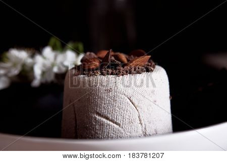 Paskha is a festive dish made in Eastern Orthodox countries. Curd Easter and bunch of flower in close up on the dark background