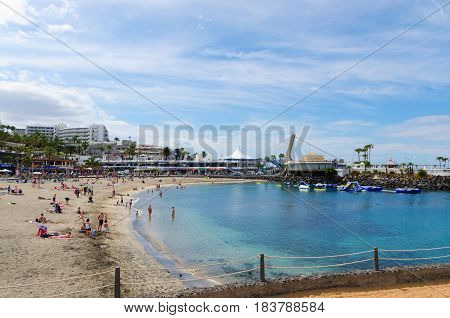 PLAYA LAS AMERICAS; Canary islands, Tenerife, Spain - March 22, 2017.  View of la playa La Pinta in Puerto Colon. It is a small beach with fine grayish (volcanic) sand and transparent, calm water.