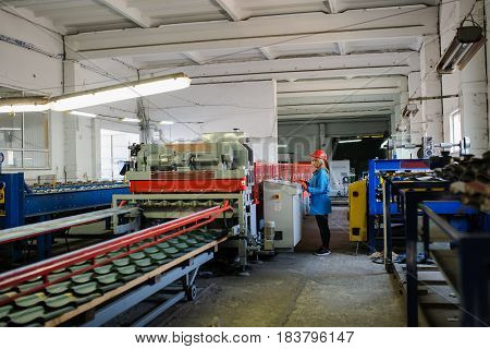 Woman In Red Safety Helmet Work As Industrial Worker