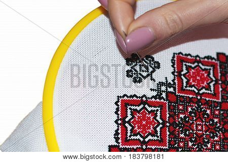Fancywork, Embroidering a cross on a white fabric with red and