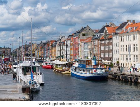 COPENHAGEN DENMARK - JULY 31 2016: Summer view of the famous Nyhavn with its colorful buildings