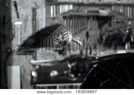 Biker aesthetic. Typical moody nice garage reflecting in the rearview mirror of old school stationary bike