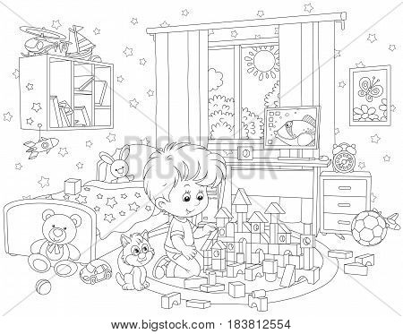 Little boy playing with bricks in his room
