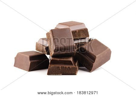 Pieces of bitter dark chocolate bar cubes on heap isolated on white background close-up view.