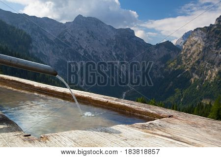Rural scenery with wooden water well.Achensee Lake area Austria Tirol.