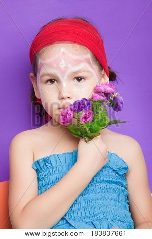 Portrait Of A Cute Child With Flowers