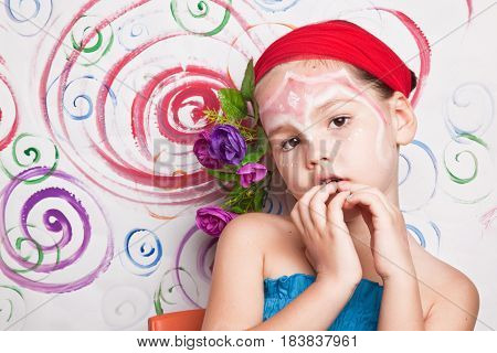 Portrait Of A Cute Child With Flowers