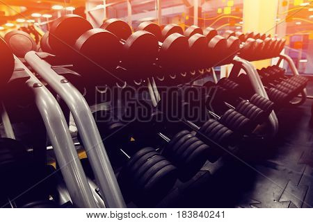 Sports equipment dumbbell rests in a row. high contrast and monochrome color tone.