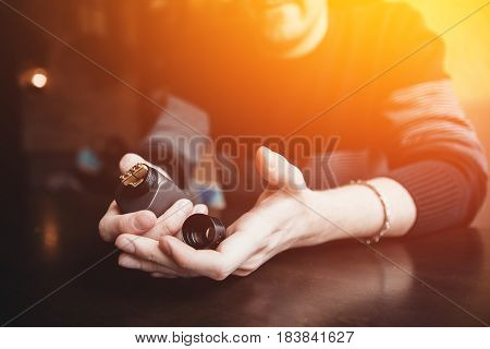 vaping man holding a mod. concept of refusal of tobacco. Vaping high contrast and monochrome color tone.