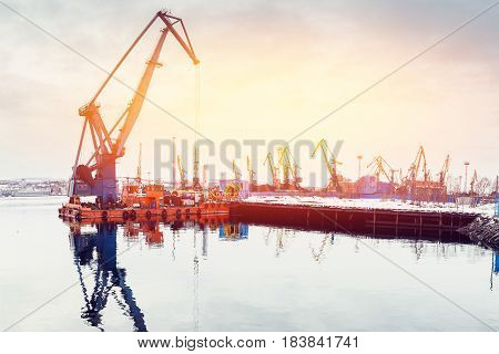 Embankment along with the river port, the crane unloads coal. high contrast and monochrome color tone.