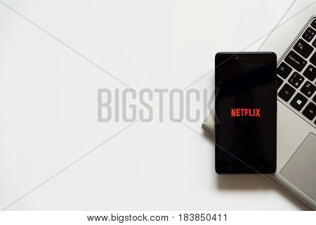 Bratislava, Slovakia, April 28, 2017: Netflix logo on smartphone screen placed on laptop keyboard. Empty place to write information.