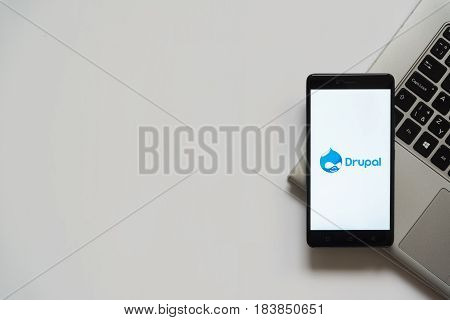 Bratislava, Slovakia, April 28, 2017: Drupal logo on smartphone screen placed on laptop keyboard. Empty place to write information.