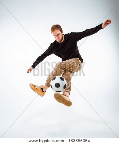 A portrait of a fan with ball on gray studio background. Freestile concept
