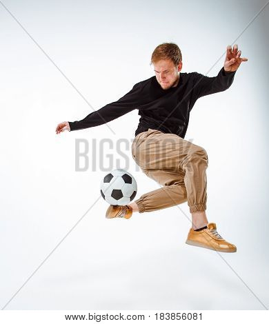 A portrait of a fan with ball on gray studio background. Freestile concept
