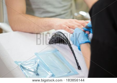 Close-up of man's hands at beautician's during manicure