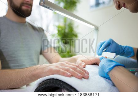 Close-up of man's hands at beautician's during manicure