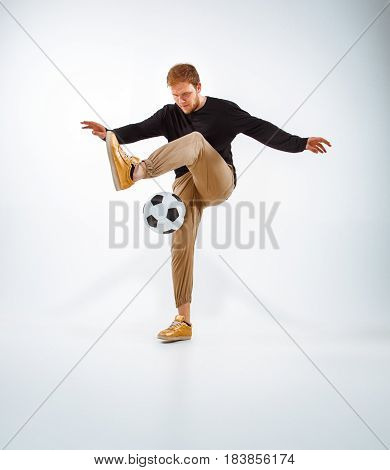 A portrait of a fan with ball on gray studio background. Freestile concept