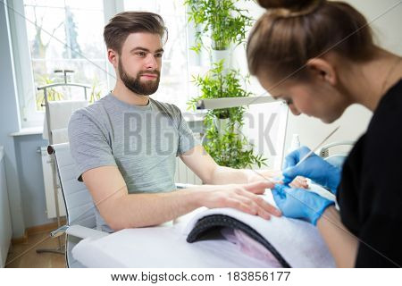 Close-up of man's hands at beautician's during manicure