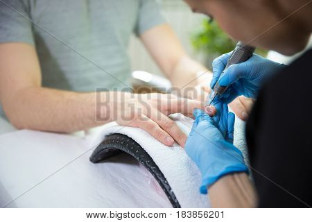 Close-up of man's hands at beautician's during manicure