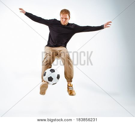 A portrait of a fan with ball on gray studio background. Freestile concept
