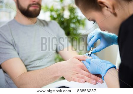 Close-up of man's hands at beautician's during manicure