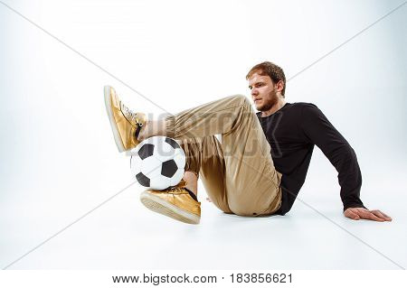 A portrait of a fan with ball on gray studio background. Freestile concept
