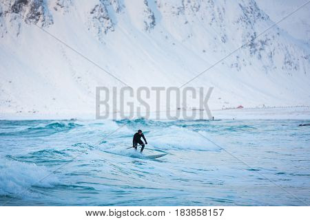 Flakstad Norway - March 18 2017: Surfer are training on the Skagsanden beach of the Lofoten Islands