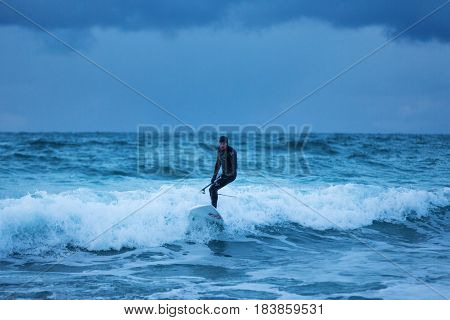 Flakstad Norway - March 18 2017: Surfer are training on the Skagsanden beach of the Lofoten Islands