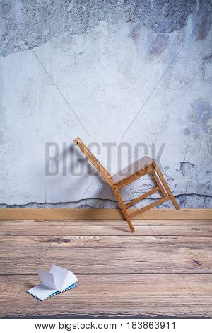Interior with awry chair and diary on the floor