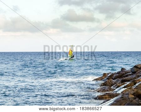 Oneglia Italy - June 14 2015: Windsurfing in the evening light