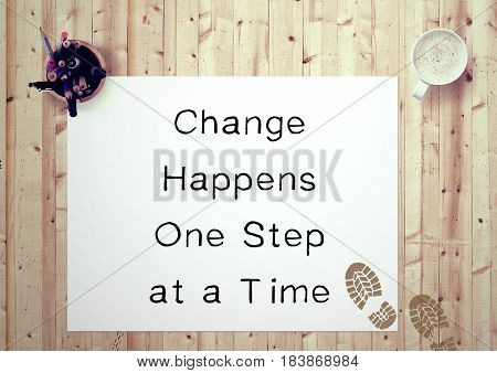 Inspiring motivation quote handwritten on a note pad change happens one step at a time. White pad paper image.