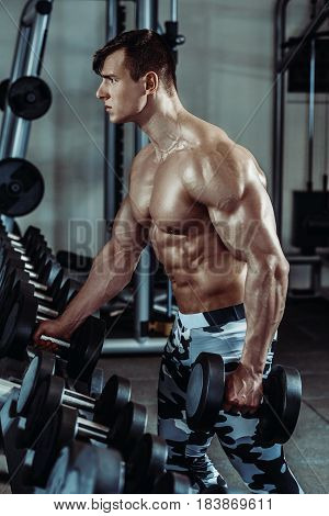 Strong muscular bodybuilder doing exercise in the gym. Part of fitness body. Sports and fitness. Fitness man in the gym. Fitness training