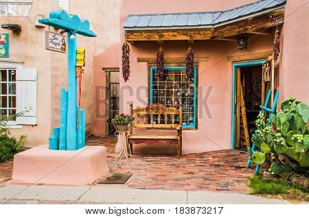 Albuquerque USA - July 28 2015: Old town plaza at hidden patio with San Pasquals shop and decorative sidewalk with brick paths flowers dried chiles and gardens