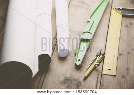 drawings and stationery on the wooden table