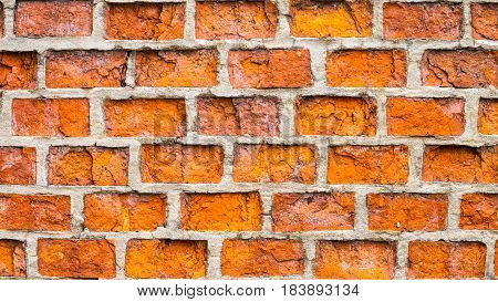 Textured old orange rick wall with horizontal lines