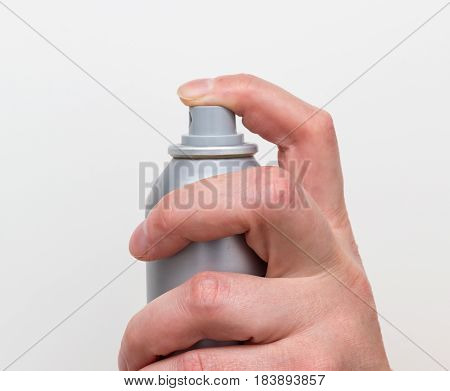 Spraying deodorant isolated on a white background