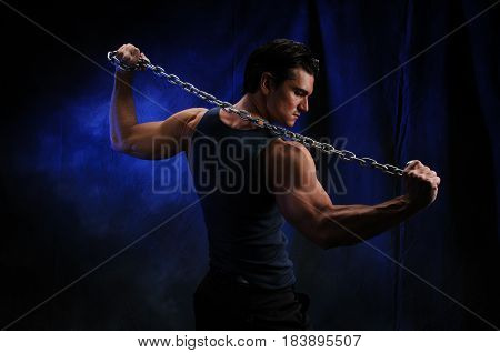 The sexy man is flexing his muscles