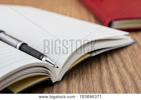 Book With Pen, Mobile And Keyborad On Desk