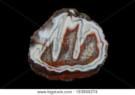 A cross section of the stalactite agate stone with quartz geode. Multicolored silica rings colored with metal oxides are visible. Origin: Asni Atlas Mountains Morocco.